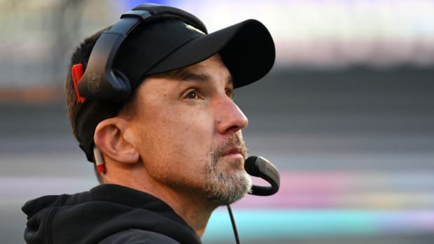 Saints coach Dennis Allen stands on the sidelines during a game.